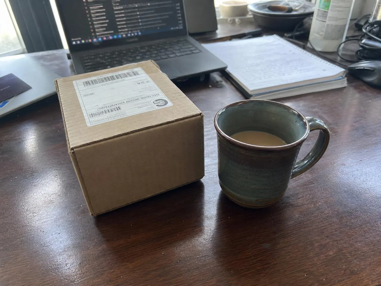 NovaPept package delivered to a home office desk beside a coffee mug and laptop